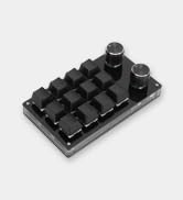 a close up of a black metal keyboard with a black base.