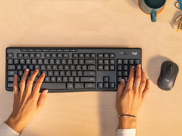 zoom of a woman using mk370 combo for business wireless keyboard and mouse