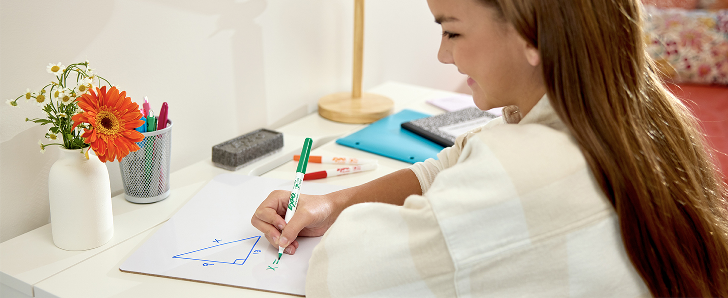 Girl doing geomtery homework with dry erase marker