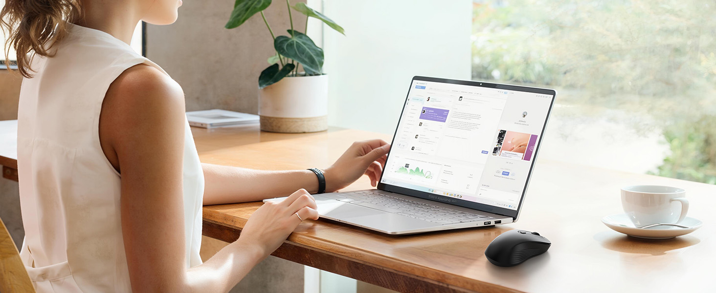 Lifestyle product image showing person working at desk with laptop, mouse, and coffee cup in casual home office setting.