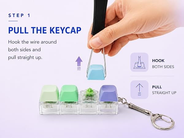An adult uses the wire end of the puller to hook both sides of a keycap and pull it straight up.