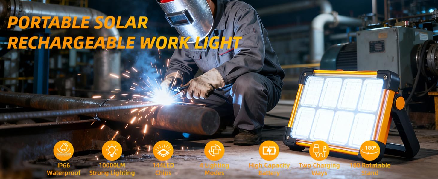 Welder using portable solar rechargeable LED work light at industrial pipe job site night