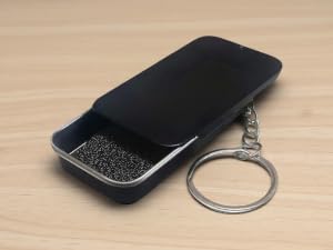 gaming finger sleeve in a small iron box