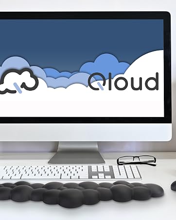 Black cloud wrist rest and mouse wrist rest on neat desk in front of computer with natural lighting
