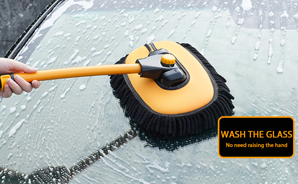 Yellow and black car wash brush cleaning a wet car windshield. Text overlay reads 'WASH THE GLASS'.