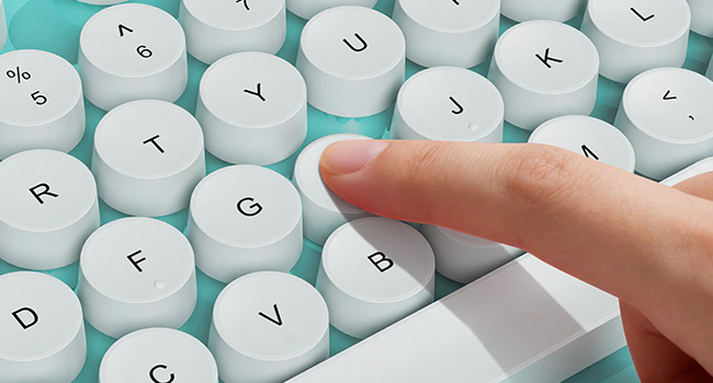 Finger pressing tiffany blue round keycaps on wireless keyboard for smooth responsive typing feel
