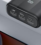 Portable battery pack with digital display showing 0:01. Features three USB ports for charging multiple devices simultaneously. Textured black exterior.