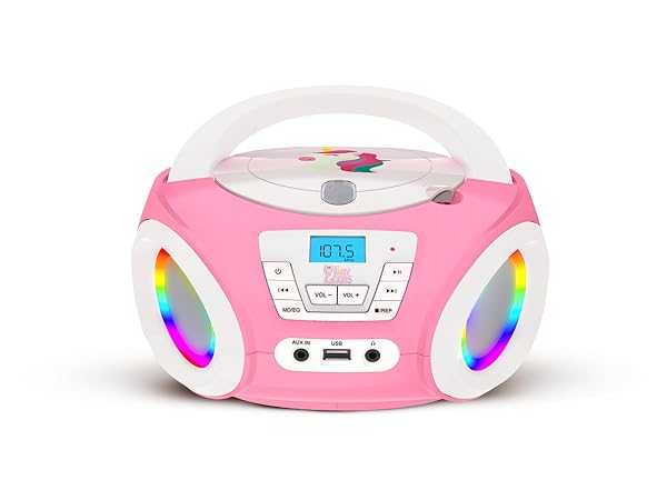 Pink and white boombox or stereo system with digital display and multiple control buttons, featuring rounded design with speaker grilles.