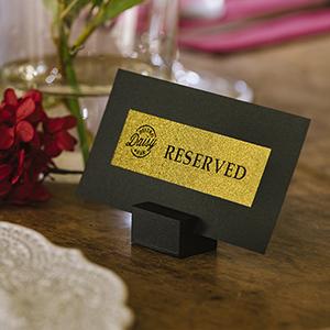 reserved label with black text on a gold glitter background