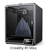Creality K1 Max 3D printer with enclosed build chamber, displaying a blue pyramid-shaped object in progress.