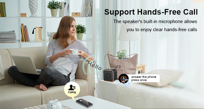 a woman sitting on a chair with a speaker on her lap.