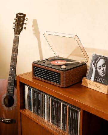 Wooden shelf displaying vintage audio equipment including acoustic guitar on left, turntable with speakers in center, and vinyl records stored below.