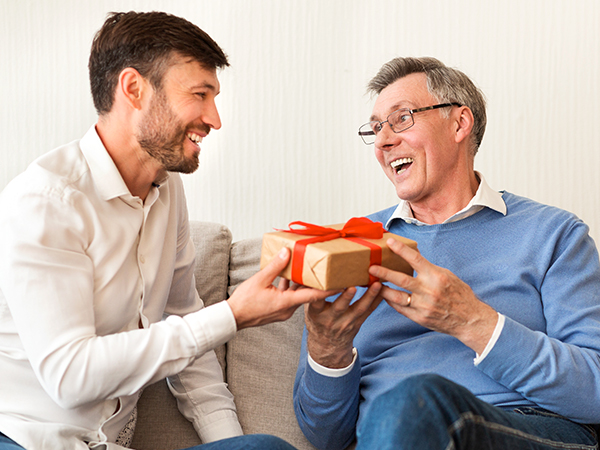 a man receiving a gift from an older man