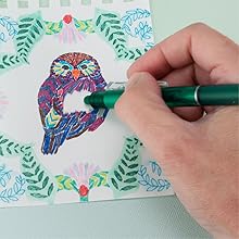 Photo shows person erasing colored pen from a drawing with the FriXion Clicker eraser