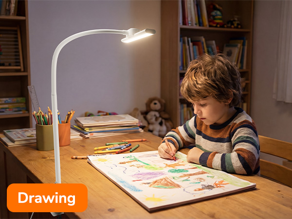 Text reads 'Drawing'. Series of images showing desk lamp illuminating drawing surface as someone works on artwork at a table.