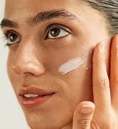woman applying after sun soothing lotion to her face