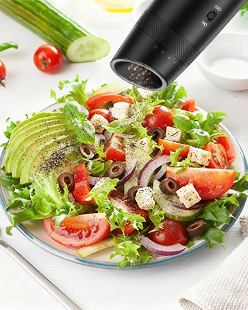 The grinder is being used to add fresh pepper to a dish
