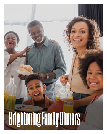 A bright dining room filled with a joyful family of five preparing for a meal together.