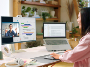 a woman having a video call using brio 100 full hd webcam for meetings and streaming