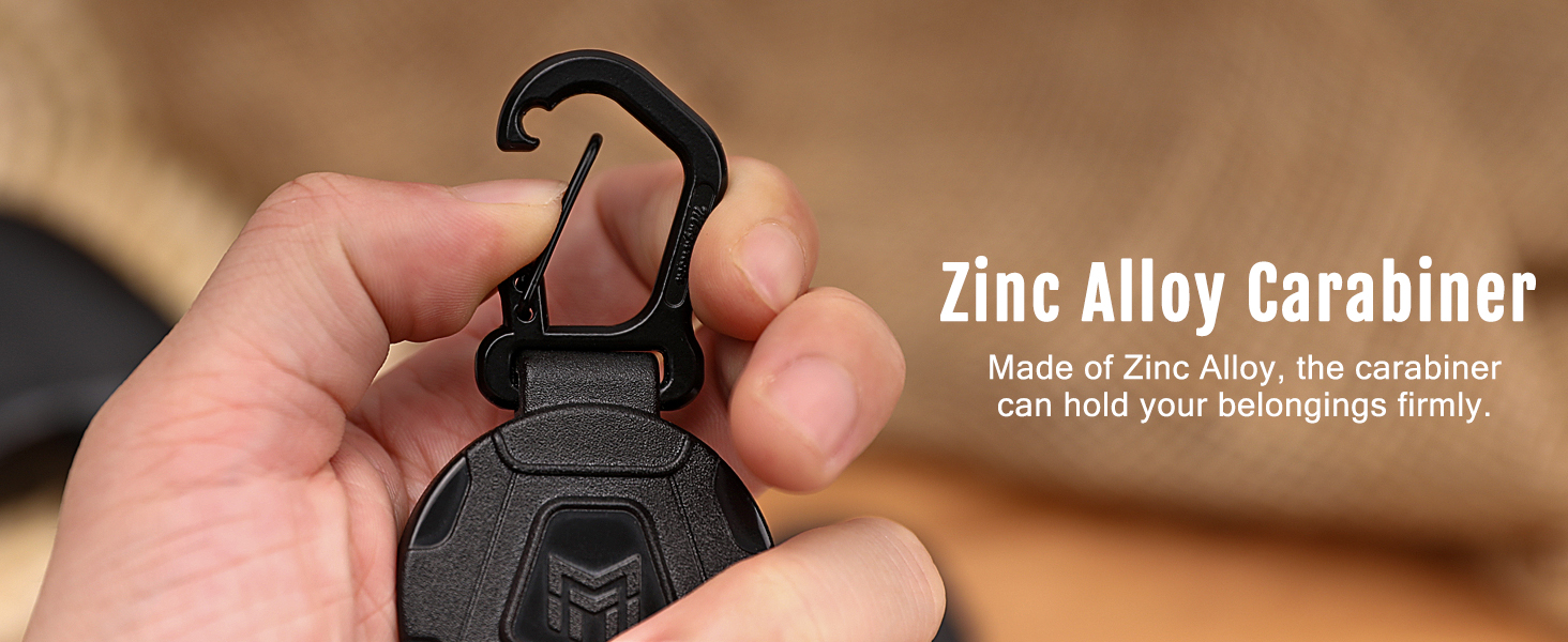 a close up of a person holding a metal keychain