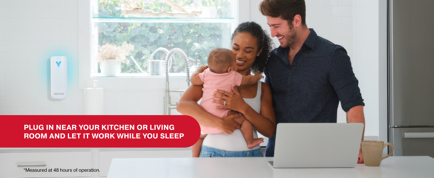 Family in bright kitchen smiling near Vector trap with message to plug in and let it work overnight.