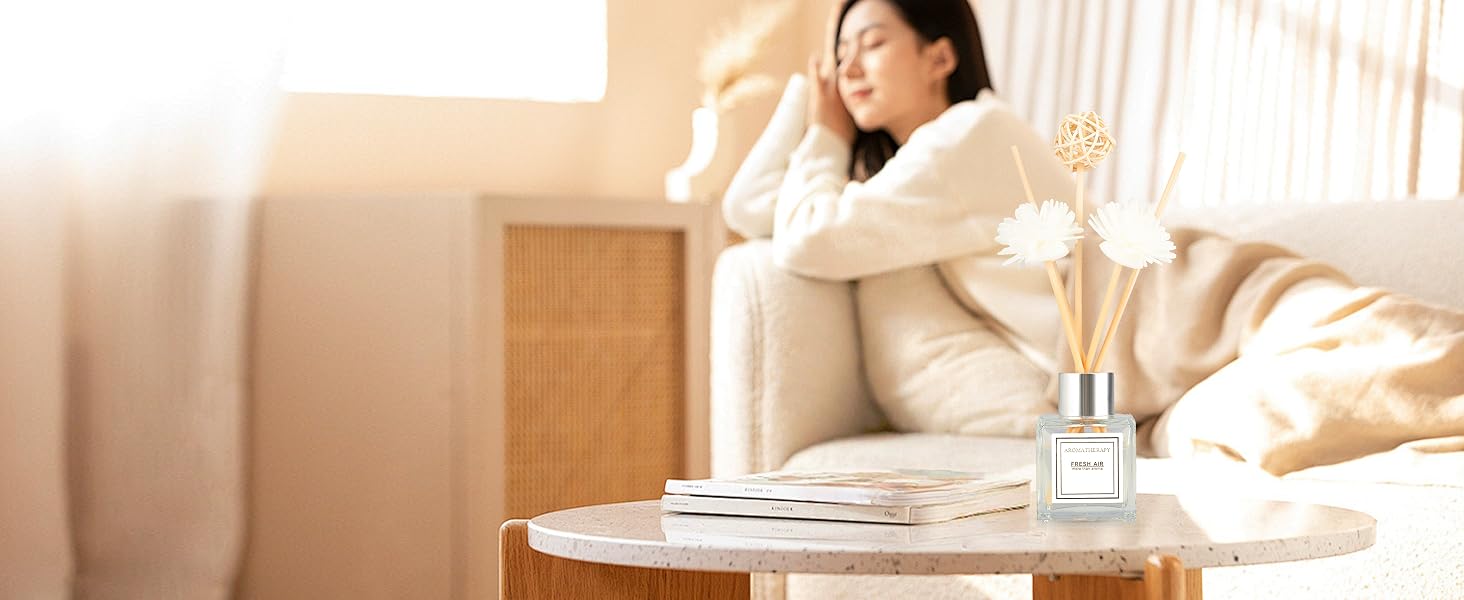 Interior design scene showing minimalist living space with white furniture, natural lighting, and modern decor elements.