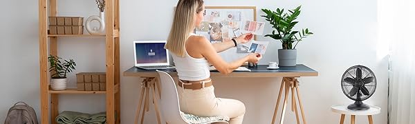 Woman working in an office with matte black fan