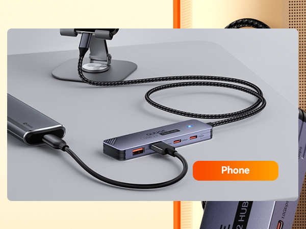 Text reads: 'Phone' Black charging cable or connector with phone indicator, shown against beige background.