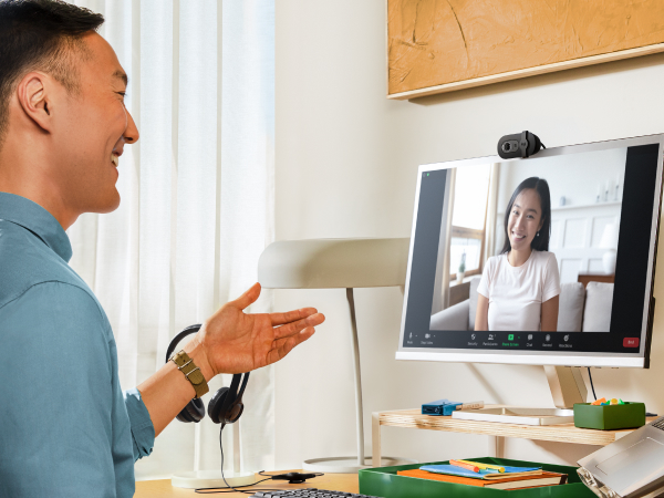 a man having a video call using brio 101 full hd webcam for meetings and streaming