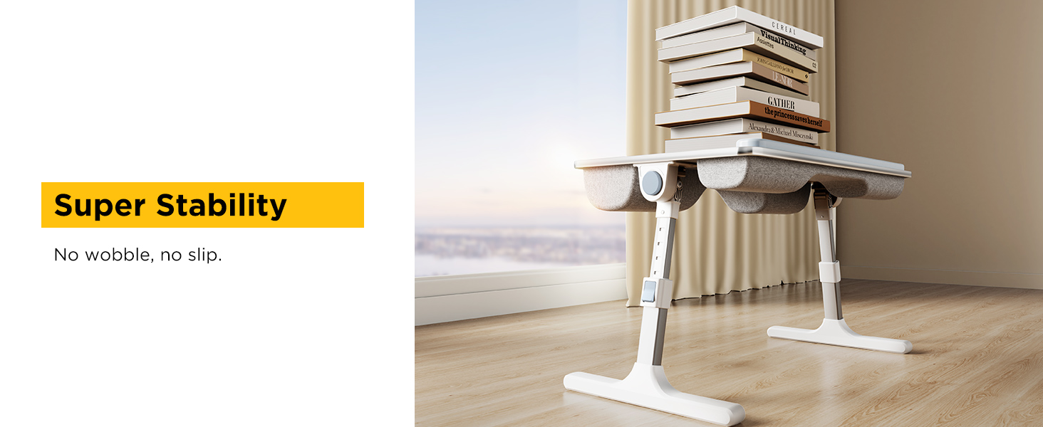 Stable adjustable lap desk shown holding heavy stack of books on hardwood floor.