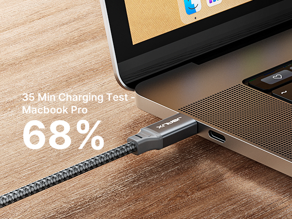 USB-C cable plugged into laptop, showing 68% charge after 35 minutes. Cable has braided design for durability.