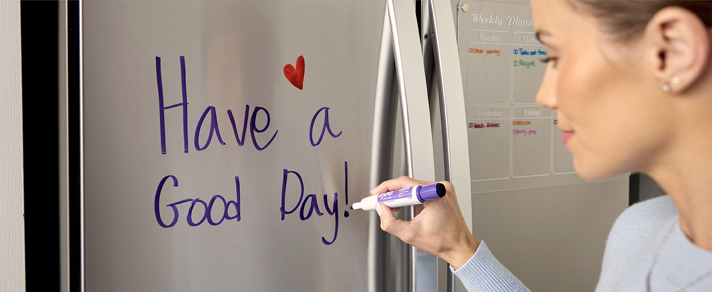 Woman writing on fridge, Have a good day