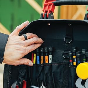 man reaches into backpack for color coded nut setters