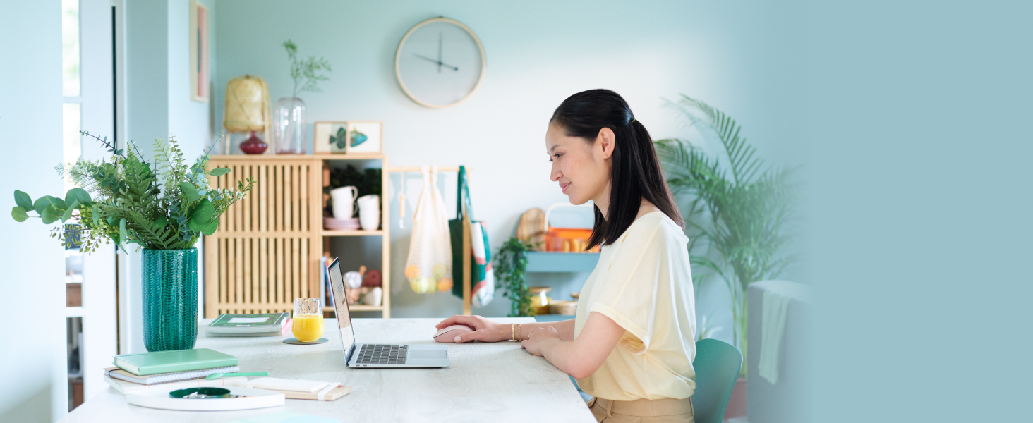 a woman using signature m550 wireless white mouse with silent clicks
