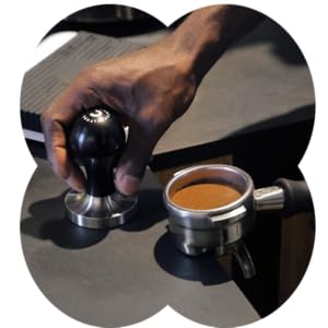 Photo of a person tamping espresso