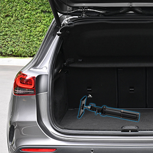 Interior view of a car's cargo area, showing an open hatchback with a blue folding bicycle visible inside the trunk space.