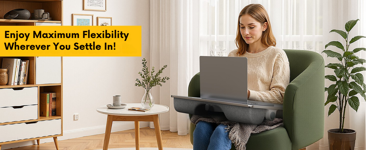 Woman using laptop lap desk with leg support while seated in armchair near bright window.