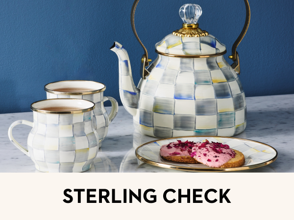 An enamel tea kettle sitting on a stand. Text reads: &amp;#34; Sterling Check.&amp;#34;