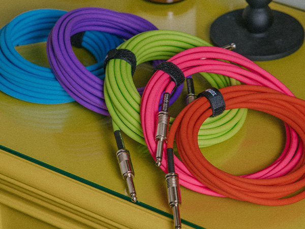 blue, purple, green, pink, orange guitar cable