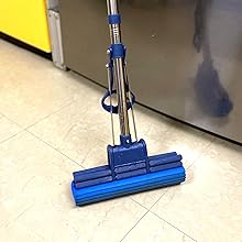 a blue vacuum cleaner on a tile floor.