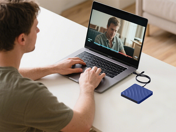 Series of images showing person working at laptop with blue mousepad on desk during video call session. Multiple angles of workspace setup with laptop screen visible.