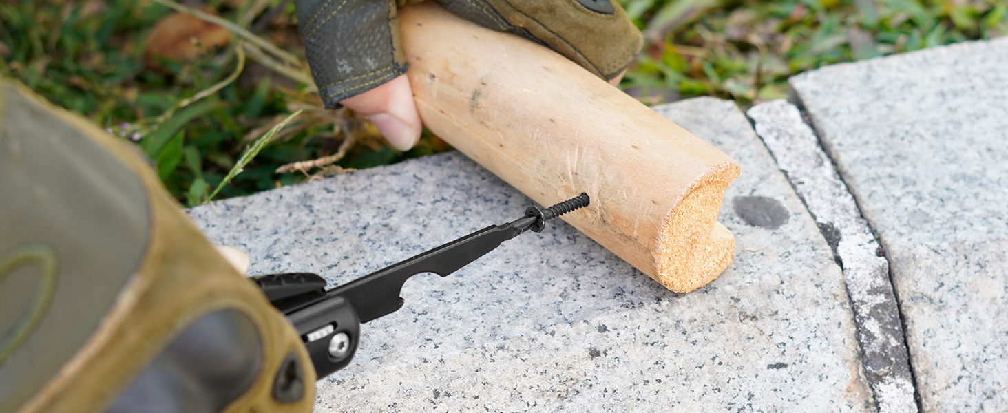 Close-up of a metal file tool being used on a cork surface against a stone or concrete background.