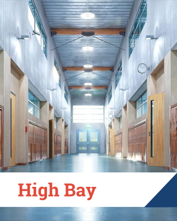 Spacious high-ceiling school hallway with high bay lighting and lockers along both walls.