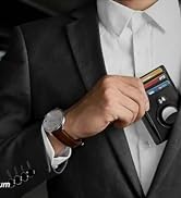 Close-up of a person in a suit jacket holding a slim, black card holder or wallet, with multiple cards visible.