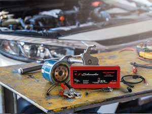 Car battery charger and maintainer has quick-connect harness for fast hook up of two connectors.