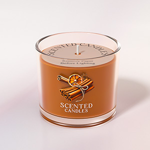 Orange-colored scented candle in a clear glass container with decorative logo and text details on the label.