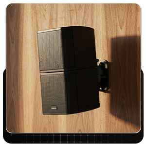 Speaker attached to wood-stud wall using a wall speaker mount with neat cable routing.