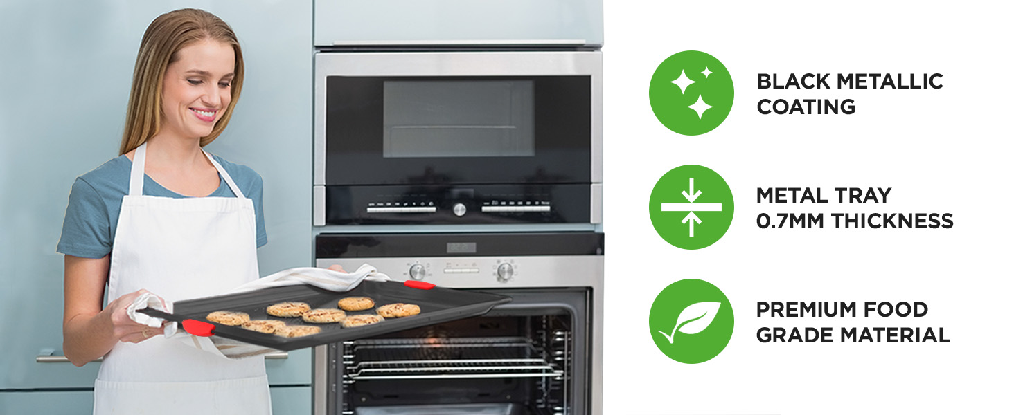 woman holding non stick cookie sheet with freshly baked cookies kitchen baking using baking pan