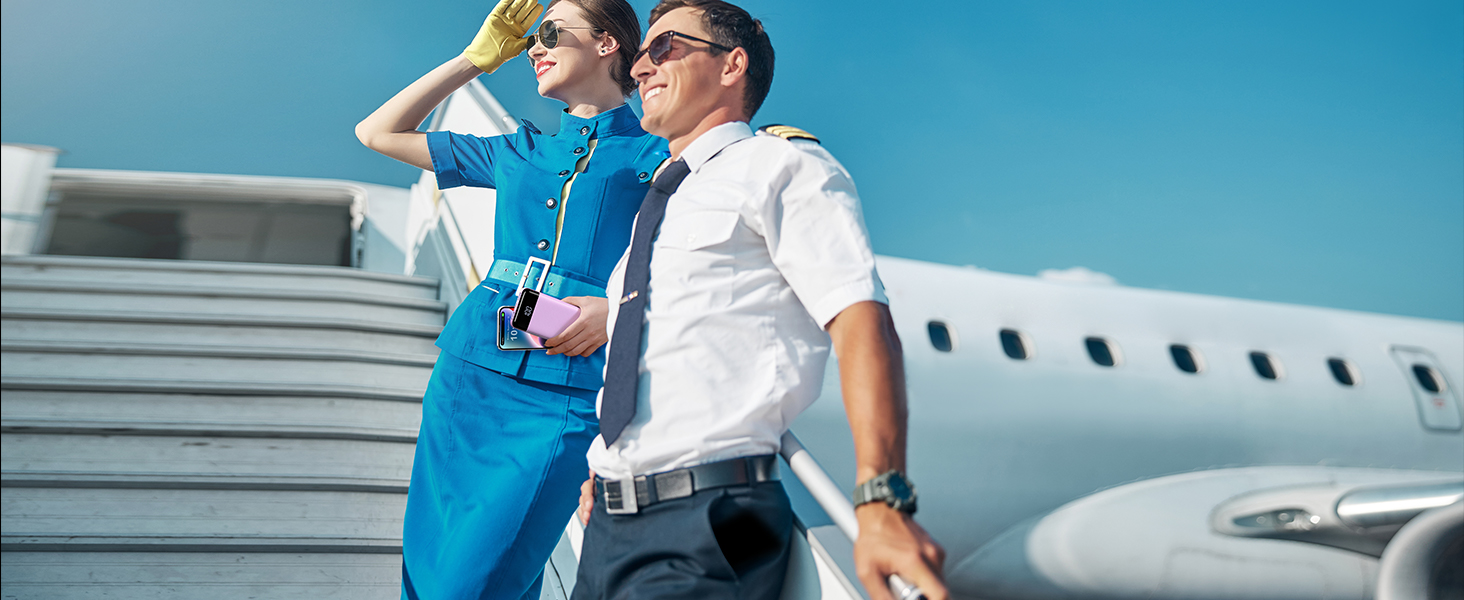 a man and a woman standing on an airplane.