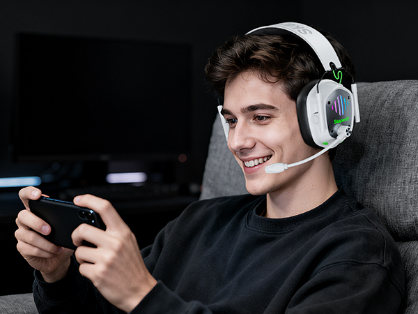 Series showing gaming interaction with mobile device while wearing white gaming headphones, captured from multiple angles in dim lighting.